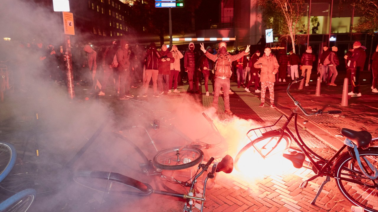 THE HAGUE NETHERLANDS - NOVEMBER 12: A flare burns on a barricade of bicycles built by antivaxxers and anti-lockdown protesters on November 12, 2021 in The Hague, Netherlands. Clashes erupt between anti-lockdown protesters and anti-riot forces as the Dutch government announce new measures to counter a new wave of Covid-19 virus infections. (Photo by Pierre Crom/Getty Images)