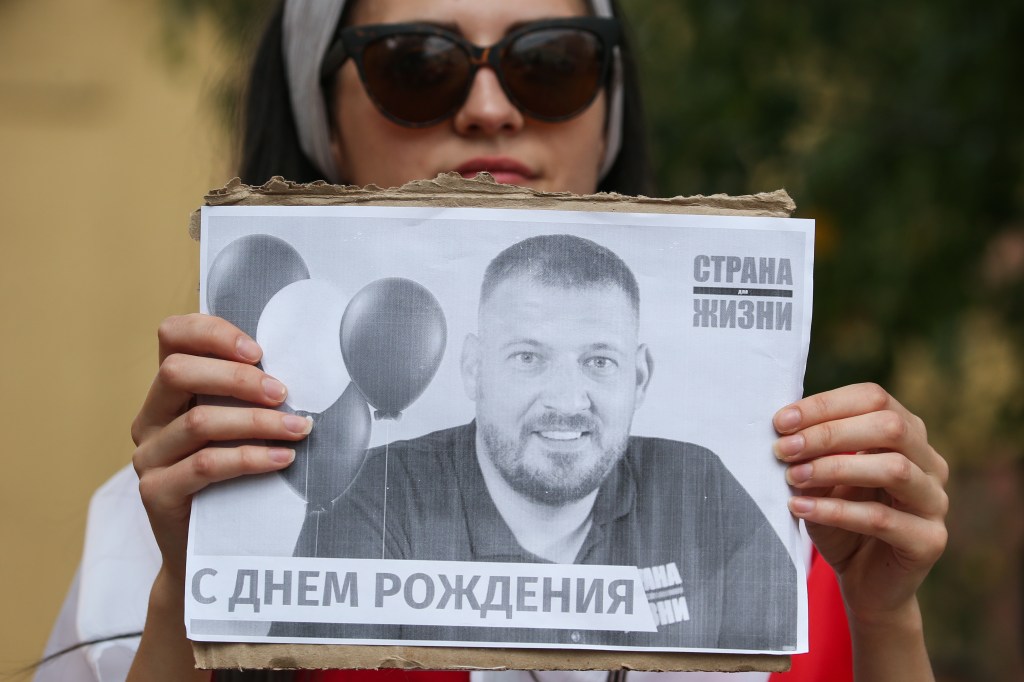 MINSK, BELARUS - AUGUST 18, 2020: An opposition activist holds a poster reading 'Happy birthday' during a rally outside detention facility no 1 where blogger Sergei Tikhanovsky is held. After being refused in registration as a presidential candidate, Tikhanovsky was arrested, and his wife Svetlana Tikhanovskaya came forward as a candidate, later turning into the leader of the opposition. Since the announcement of the 2020 Belarusian presidential election results on August 9, mass protests against the election results have been erupting in major cities across Belarus. Natalia Fedosenko/TASS (Photo by Natalia FedosenkoTASS via Getty Images)