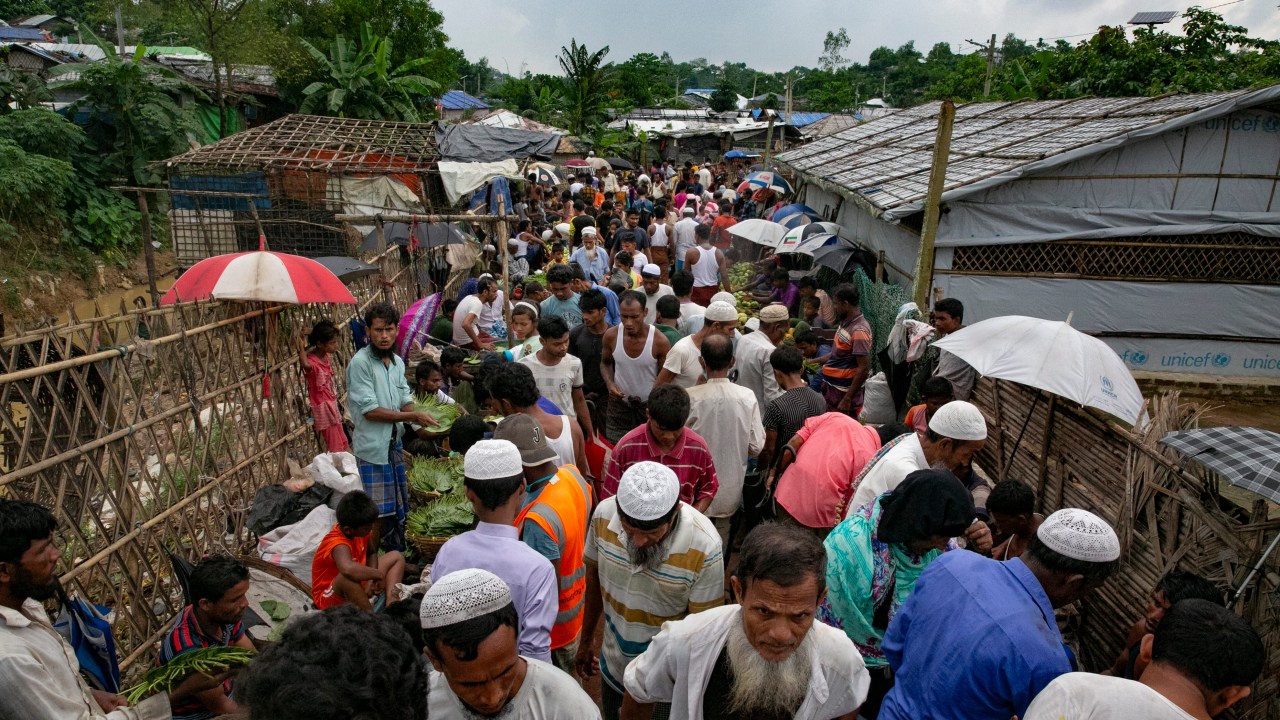 COX'S BAZAR, BANGLADESH - AUGUST 11: People walk through a marketplace in a Rohingya refugee camp on August 11, 2021 in Cox's Bazar, Bangladesh. On Tuesday, Bangladesh started a COVID-19 vaccination drive for Rohingya refugees. Nearly 48,000 Rohingya refugees will be inoculated with the help of the UN agencies. (Photo by Allison Joyce/Getty Images)