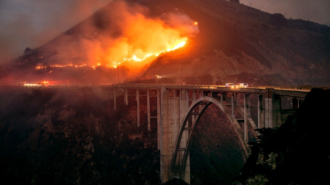 Incêndio atinge a ponte Bixby, em Big Sur, na Califórnia, na manhã de sábado (22). Apenas 5% das chamas foram controladas até agora -