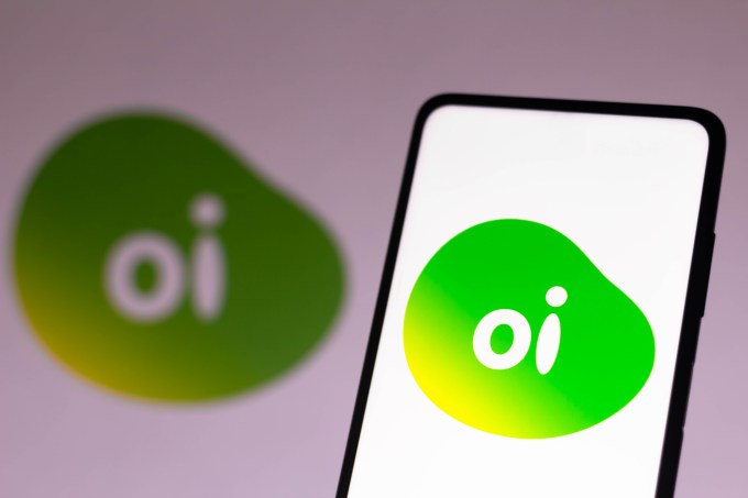 In this photo illustration the Oi logo seen displayed on a