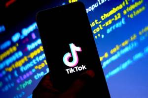 In this photo illustration a Tiktok logo seen on displayed a