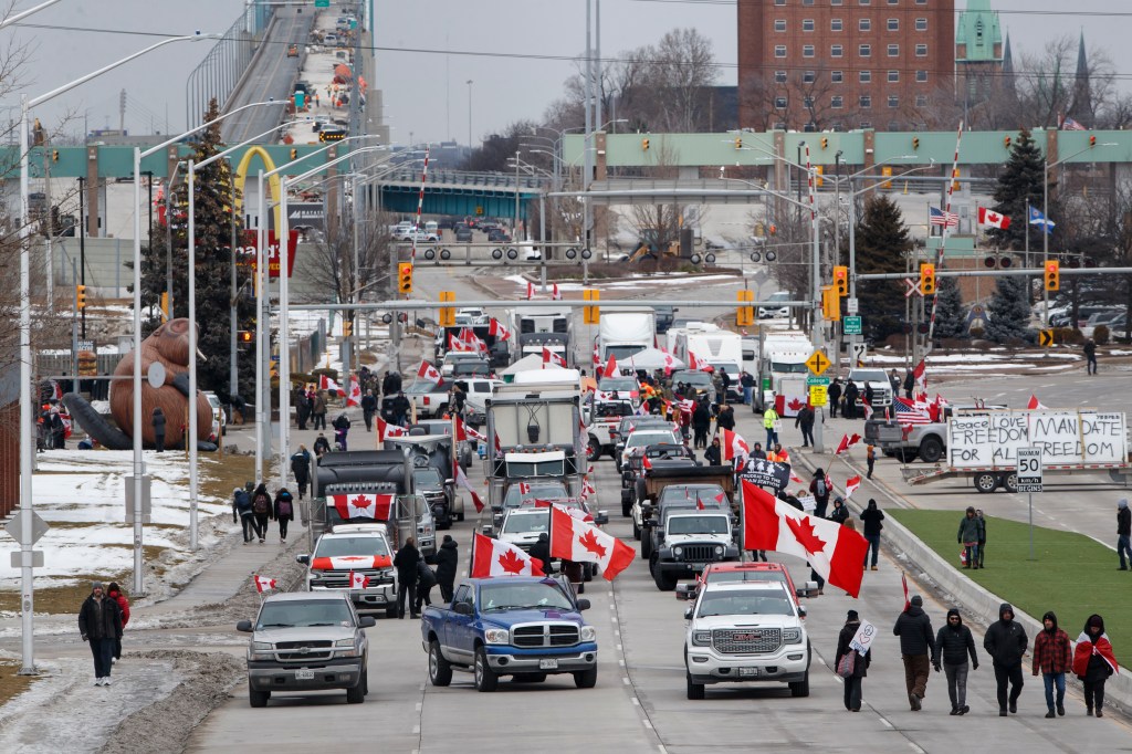 WINDSOR, ON - February 10: Protestors and supporters set up at a blockade at the foot of the Ambassador Bridge, sealing off the flow of commercial traffic over the bridge into Canada from Detroit, on February 10, 2022 in Windsor, Canada. As a convoy of truckers and supporters continues to occupy Ottawas downtown, blockades and convoys have popped up around the country in support of the protest against Canada's COVID-19 vaccine mandate for cross-border truckers. (Photo by Cole Burston/Getty Images)