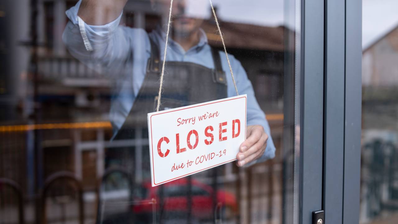 Man closing his small business during COVID-19 pandemic.