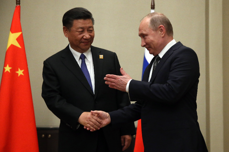 Russian President Vladmir Putin (R) greets Chinese President Xi Jinping (L) during their meeting in Astana, Kazakhstan, June,8,2017.
