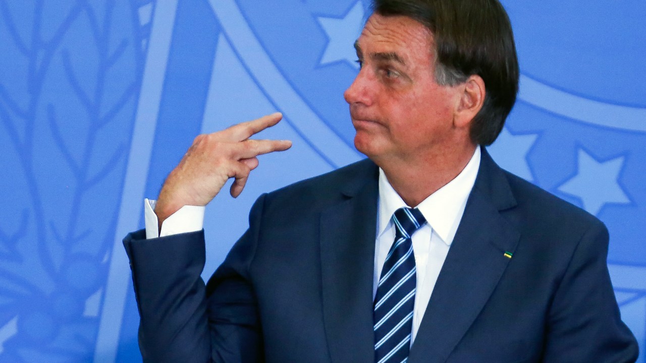 (FILES) In this file photo taken on February 02, 2022 Brazilian President Jair Bolsonaro gestures as he attends a ceremony on retirement issues of the Social Security Institute, in Brasilia.. - Brazilian President Jair Bolsonaro said on March 2, 2022 that Brazil may face difficulties importing agricultural fertilizers from Russia due to the invasion of Ukraine, and to reduce external dependence on that product he defended the exploitation of minerals in indigenous territories. (Photo by Sergio Lima / Poder360 / AFP)