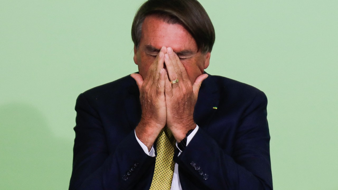 Brazilian President Jair Bolsonaro gestures during the commemoration of the Rare Disease Day at the Planalto Palace in Brasilia, on March 3, 2022. (Photo by Sergio Lima / AFP)