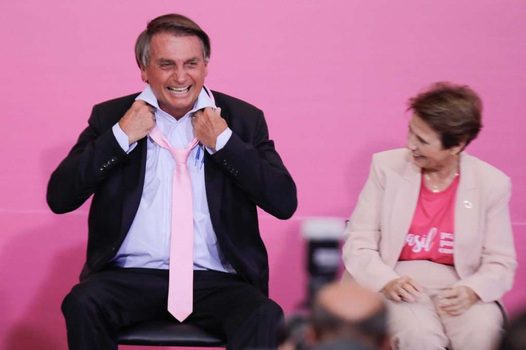 Brazilian President Jair Bolsonaro wears a pink tie during a ceremony marking International Women's Day at Planalto Palace, in Brasília, on March 8, 2022. (Photo by Sergio Lima / AFP)