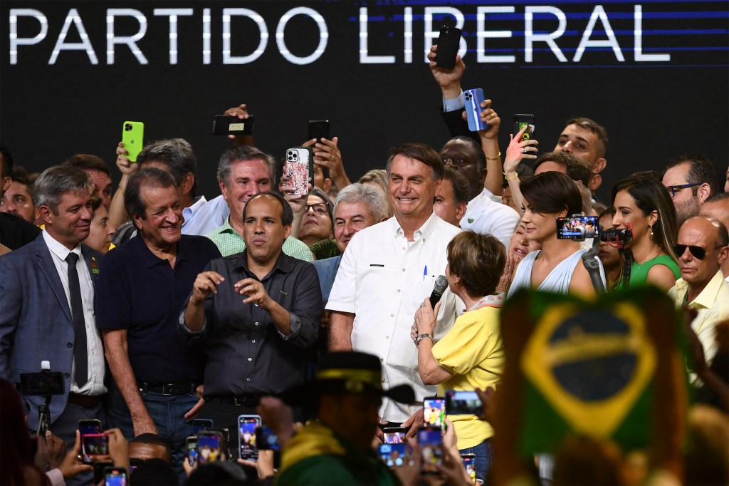 Brazil's President Jair Bolsonaro takes part in an event by the right-wing Liberal Party (PL), which he had officially joined last November in order to run in the October 2022 presidential election, at a convention centre in Brasilia, on March 27, 2022. - No formal announcements were made during the rally as, according to the Brazilian law, candidates for the October vote will only be considered official after they register with electoral authorities in August. (Photo by EVARISTO SA / AFP)
