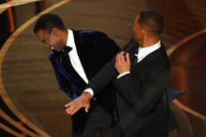 US actor Will Smith (R) slaps US actor Chris Rock onstage during the 94th Oscars at the Dolby Theatre in Hollywood, California on March 27, 2022. (Photo by Robyn Beck / AFP)