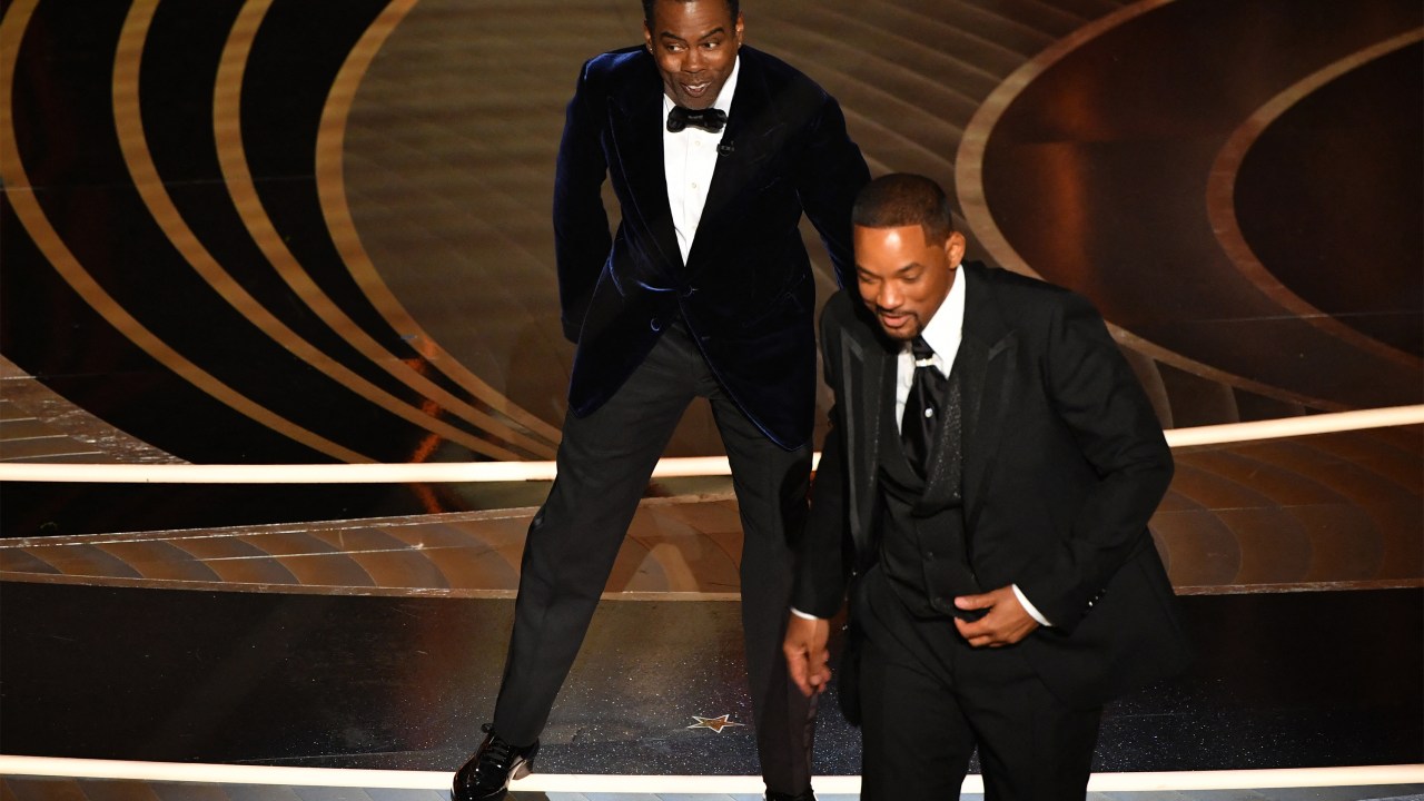 US actor Will Smith (R) walks away from US actor Chris Rock onstage during the 94th Oscars at the Dolby Theatre in Hollywood, California on March 27, 2022. (Photo by Robyn Beck / AFP)
