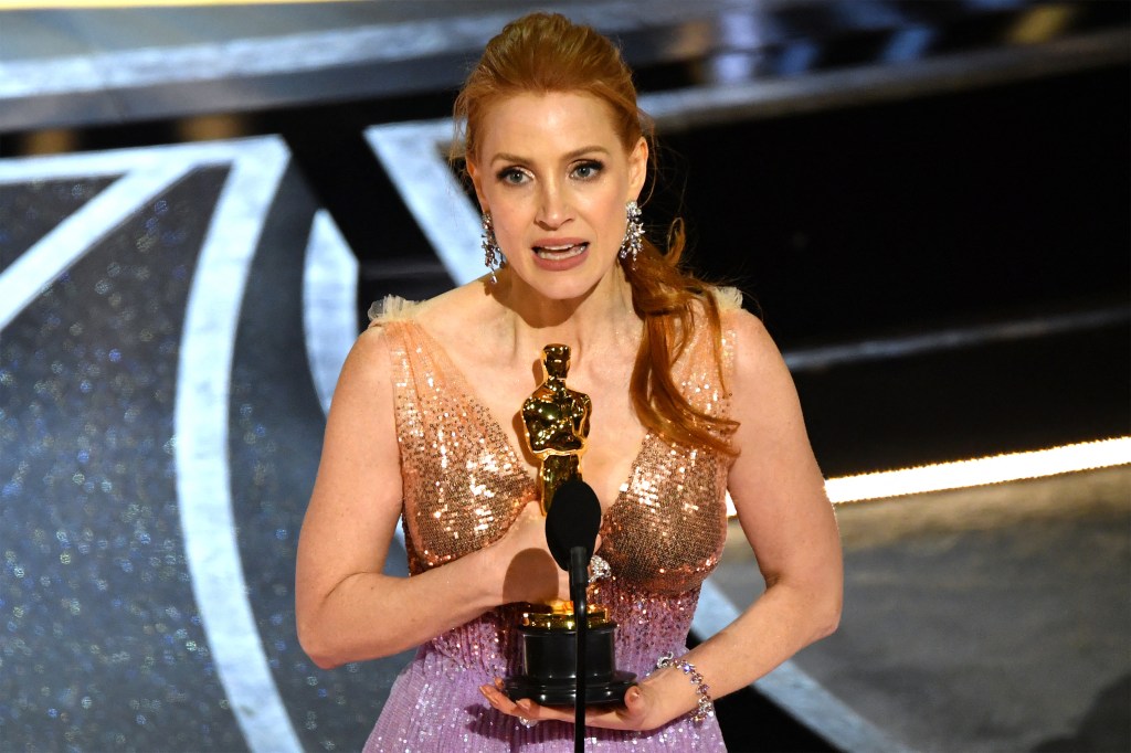 US actress Jessica Chastain accepts the award for Best Actress in a Leading Role for her performance in "The Eyes of Tammy Faye" onstage during the 94th Oscars at the Dolby Theatre in Hollywood, California on March 27, 2022. (Photo by Robyn Beck / AFP)