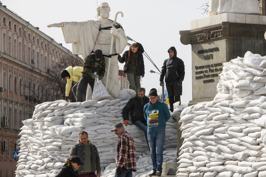 Voluntários erguem barricada em torno de estátuas de mármore em Kiev, capital da Ucrânia, na segunda-feira (28)