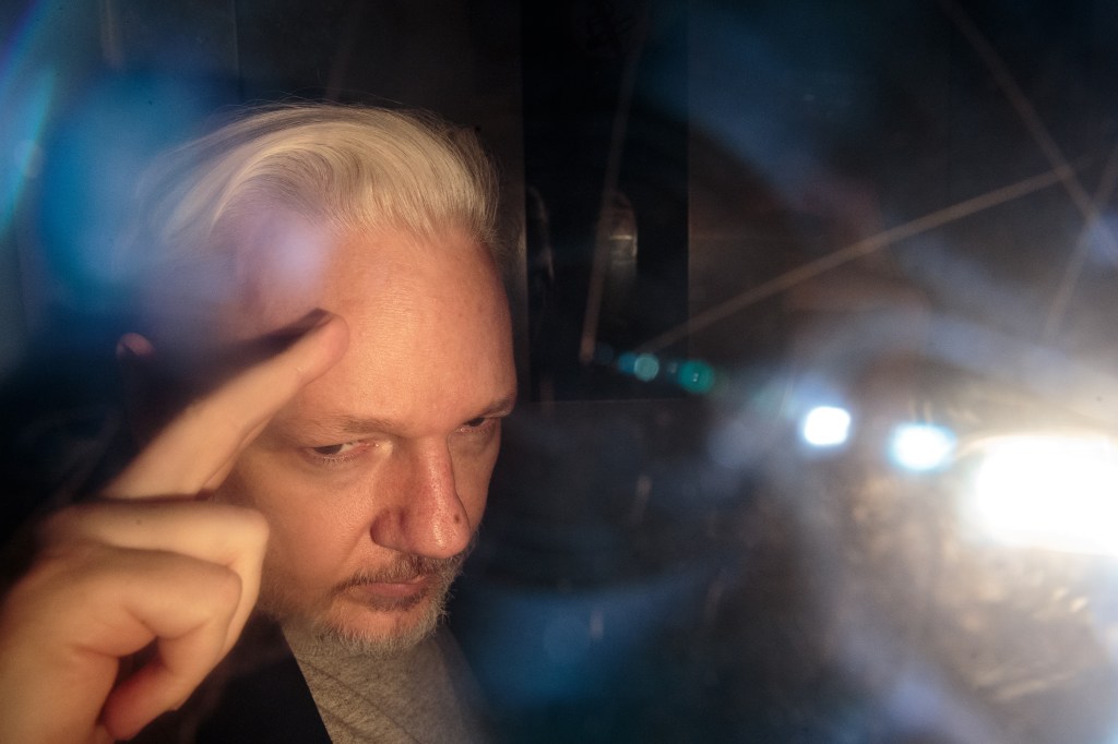 LONDON, ENGLAND - MAY 01: Wikileaks Founder Julian Assange leaves Southwark Crown Court in a security van after being sentenced on May 1, 2019 in London, England. Wikileaks Founder Julian Assange, 47, was sentenced to 50 weeks in prison for breaching his bail conditions when he took refuge in the Ecuadorian Embassy in 2012 to avoid extradition to Sweden over sexual assault allegations, charges he denies. The UK will now decide whether to extradite him to US to face conspiracy charges after his whistle-blowing website Wikileaks published classified US documents. (Photo by Jack Taylor/Getty Images)