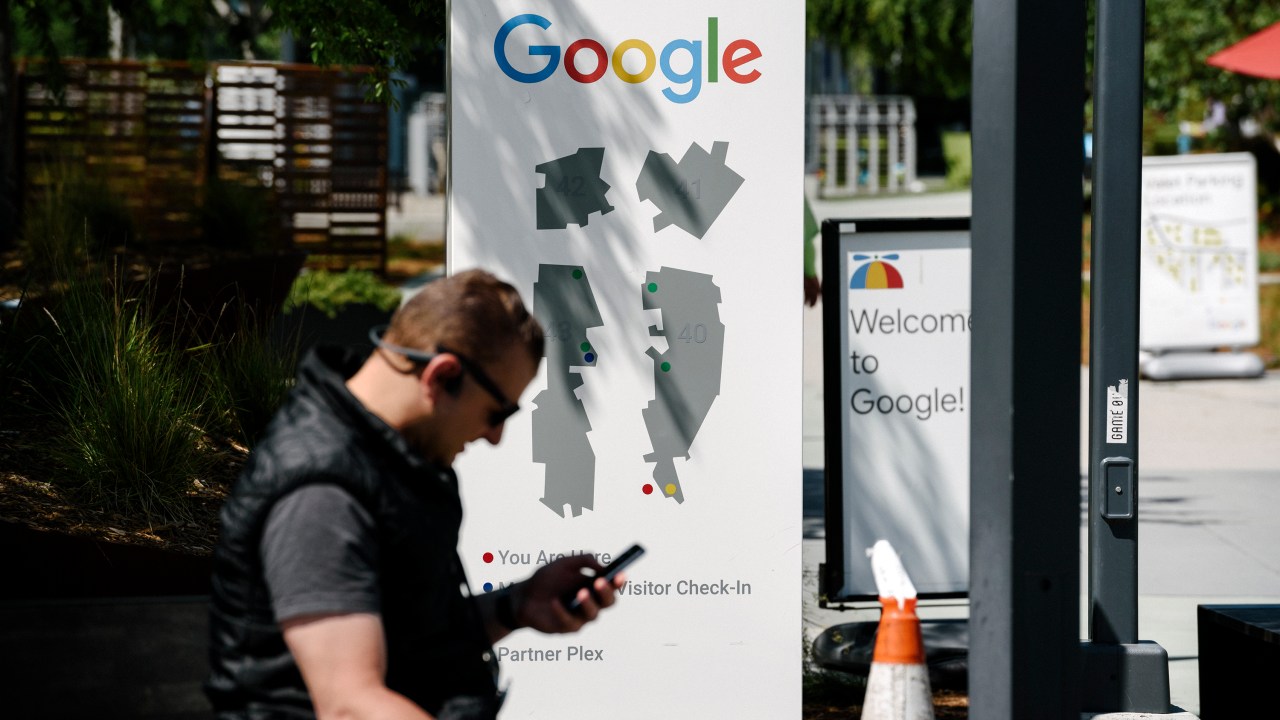 MOUNTAIN VIEW, CA - MAY 01: A man uses a mobile device on the Google campus as Google workers inside hold a sit-in to protest sexual harassment at the company, on May 1, 2019 in Mountain View, California. (Photo by Michael Short/Getty Images)