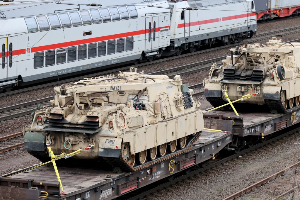 05 April 2022, Saxony-Anhalt, Magdeburg: A train carrying U.S. Army military vehicles, including M88 armored recovery vehicles, passes through Magdeburg-Sudenburg station in the evening, heading east. Photo: Peter Gercke/dpa (Photo by Peter Gercke/picture alliance via Getty Images)