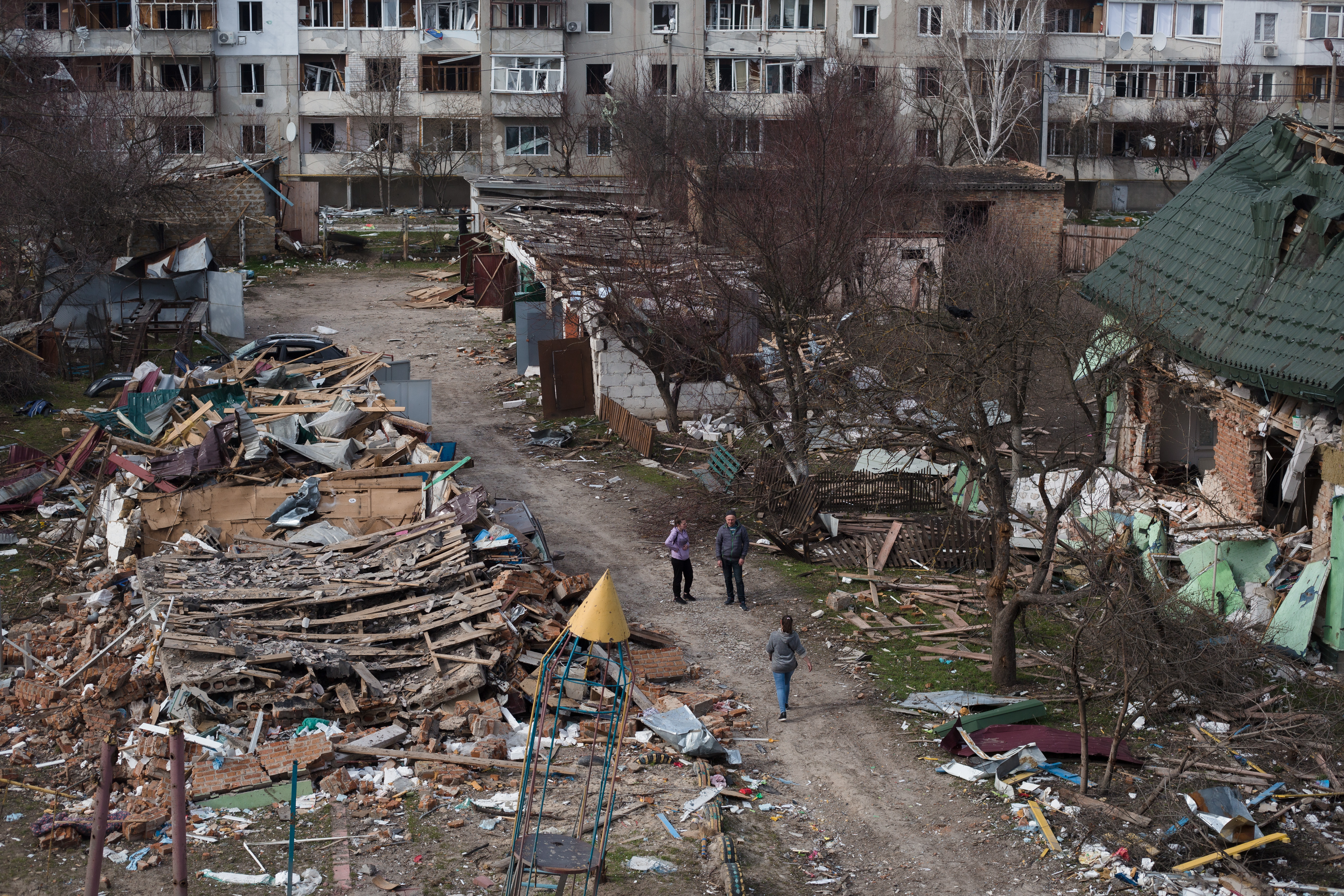 BORODIANKA, UKRAINE - APRIL 07: People walk in a destroyed residential area on April 7, 2022 in Borodianka, Ukraine. The Russian retreat from towns near Kyiv has revealed scores of civilian deaths and the full extent of devastation from Russia's failed attempt to seize the Ukrainian capital. (Photo by Anastasia Vlasova/Getty Images)