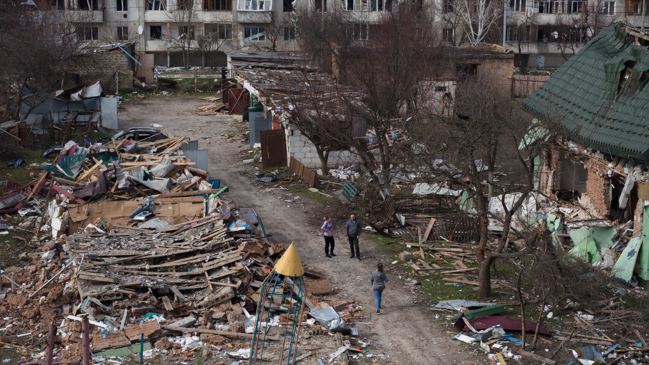 BORODIANKA, UKRAINE - APRIL 07: People walk in a destroyed residential area on April 7, 2022 in Borodianka, Ukraine. The Russian retreat from towns near Kyiv has revealed scores of civilian deaths and the full extent of devastation from Russia's failed attempt to seize the Ukrainian capital. (Photo by Anastasia Vlasova/Getty Images)