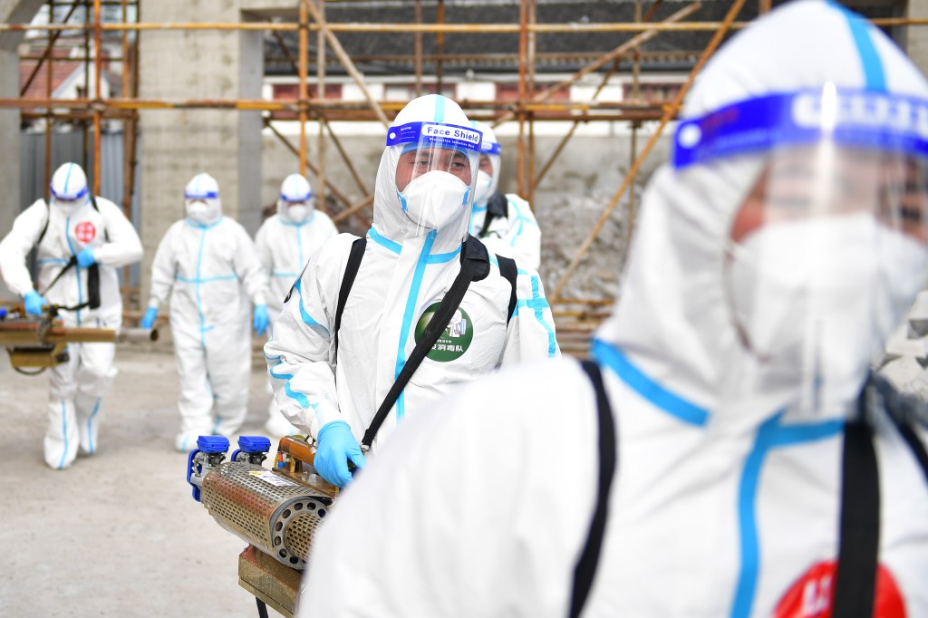 SHANGHAI, CHINA - APRIL 17: Members of a volunteer team from Lanzhou disinfect a construction site on April 17, 2022 in Shanghai, China. (Photo by Tian Yuhao/China News Service via Getty Images)