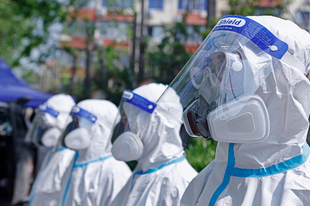 Members of a volunteer team prepare to carry out disinfection work on April 21, 2022 in Shanghai, China. (Photo by Yin Liqin/China News Service via Getty Images)