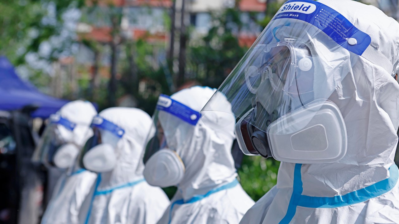 Members of a volunteer team prepare to carry out disinfection work on April 21, 2022 in Shanghai, China. (Photo by Yin Liqin/China News Service via Getty Images)