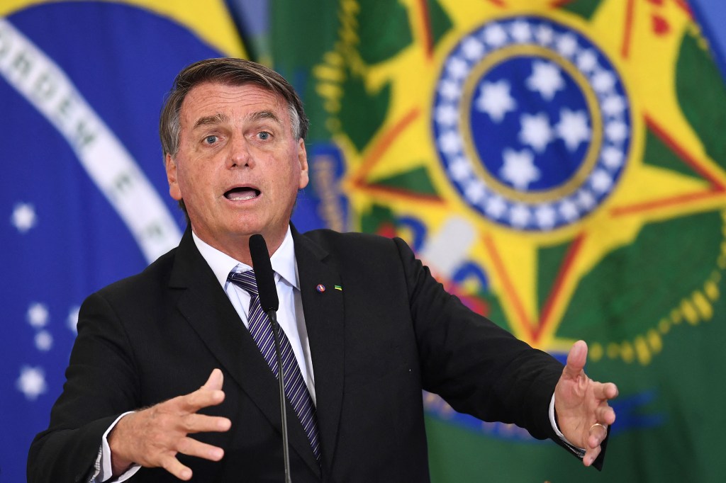 Brazilian President Jair Bolsonaro speaks during the inauguration ceremony of new ministers at the Planalto Palace in Brasilia, on March 31, 2022. - Bolsonaro on Thursday fired key ministers who will contest the October elections, including his possible running mate for defence, in a ceremony in which he praised the last military dictatorship. (Photo by EVARISTO SA / AFP)
