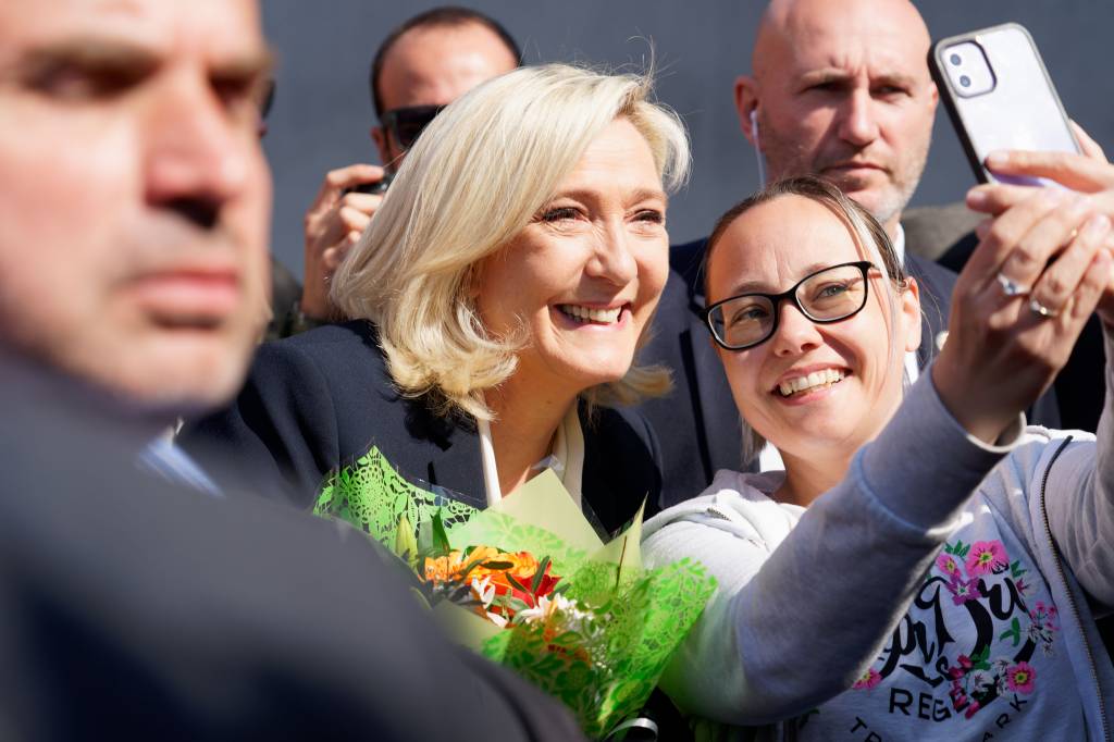 HENIN-BEAUMONT, FRANCE - APRIL 24: French far-right National Rally candidate Marine Le Pen poses with supporters as she leaves a polling station after casting her ballot for the 2nd round of the presidential elections on April 24, 2022 in Henin-Beaumont, France. Emmanuel Macron and Marine Le Pen were both qualified on Sunday April 10th for France's 2022 presidential election second round to be held on April 24. This is the second consecutive time the two candidates face-off in the final round of elections. (Photo by Sylvain Lefevre/Getty Images)
