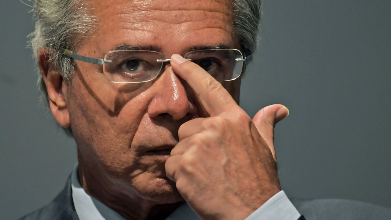 The new Brazilian Economy Minister, Paulo Guedes takes office during a ceremony in Brasilia, on January 02, 2019. - Brazl's President Jair Bolsonaro has appointed a free-marketeer, Paulo Guedes, as economy minister to push through reforms to bring down Brazil's swelling debt, mainly through privatizations, tax changes and encouraging foreign investment. (Photo by CARL DE SOUZA / AFP)