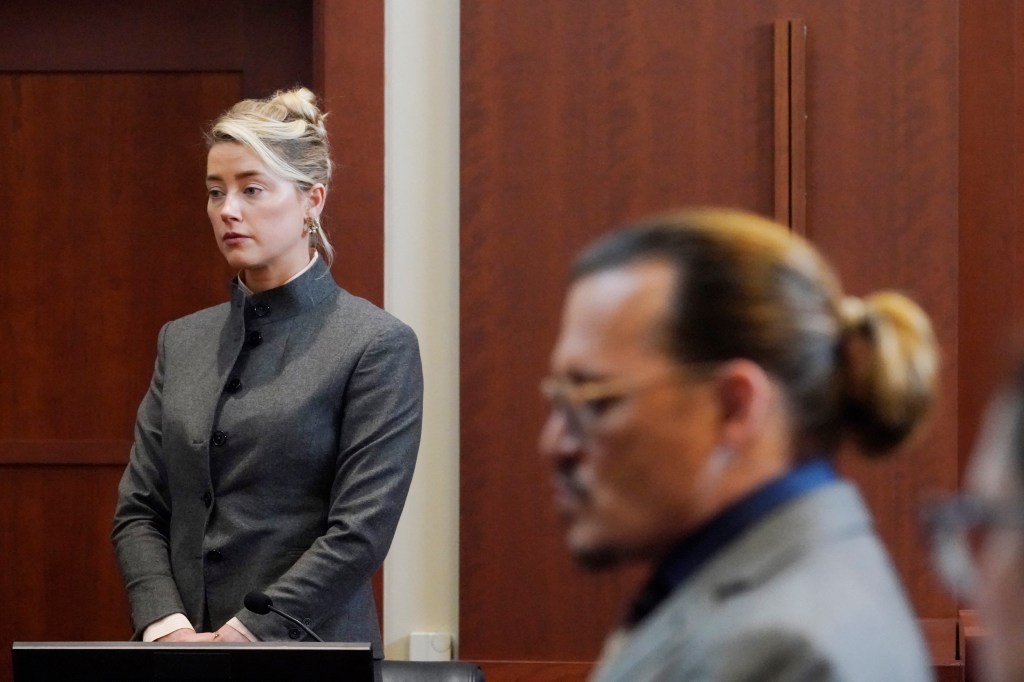 Actors Amber Heard and Johnny Depp watch as the jury leave the courtroom for a lunch break at the Fairfax County Circuit Courthouse in Fairfax, Virginia, on May 16, 2022. - Actor Johnny Depp sued his ex-wife Amber Heard for libel in Fairfax County Circuit Court after she wrote an op-ed piece in The Washington Post in 2018 referring to herself as a "public figure representing domestic abuse." (Photo by Steve Helber / POOL / AFP)