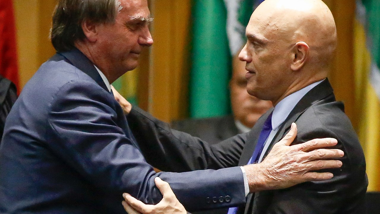 Brazil's President Jair Bolsonaro (L) greets Judge Alexandre de Moraes during an inauguration ceremony of new judges of the Superior Labor Court in Brasilia, on May 19, 2022. (Photo by / AFP)