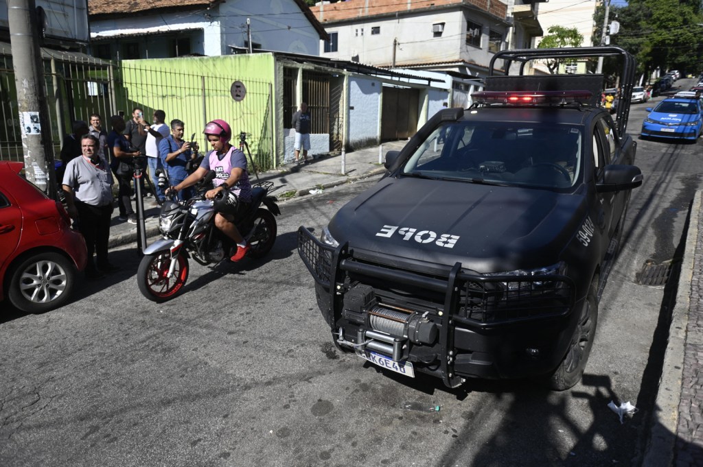 A vehicle of the Batallion of Special Police Operations (BOPE) is seen near the Getulio Vargas Hospital, where injured people were admitted after a police operation at a favela, in Rio de Janeiro, Brazil, on May 24, 2022. - A police raid in a Rio favela left 11 people dead on Tuesday, authorities said. Police said they came under gun fire as they planned to enter a slum called Vila Cruzeiro in the north of the city with the mission of locating and arresting "criminal leaders." In the ensuing gunbattle 10 alleged criminals died, as did a female resident of the favela who was hit by a stray bullet. (Photo by MAURO PIMENTEL / AFP)