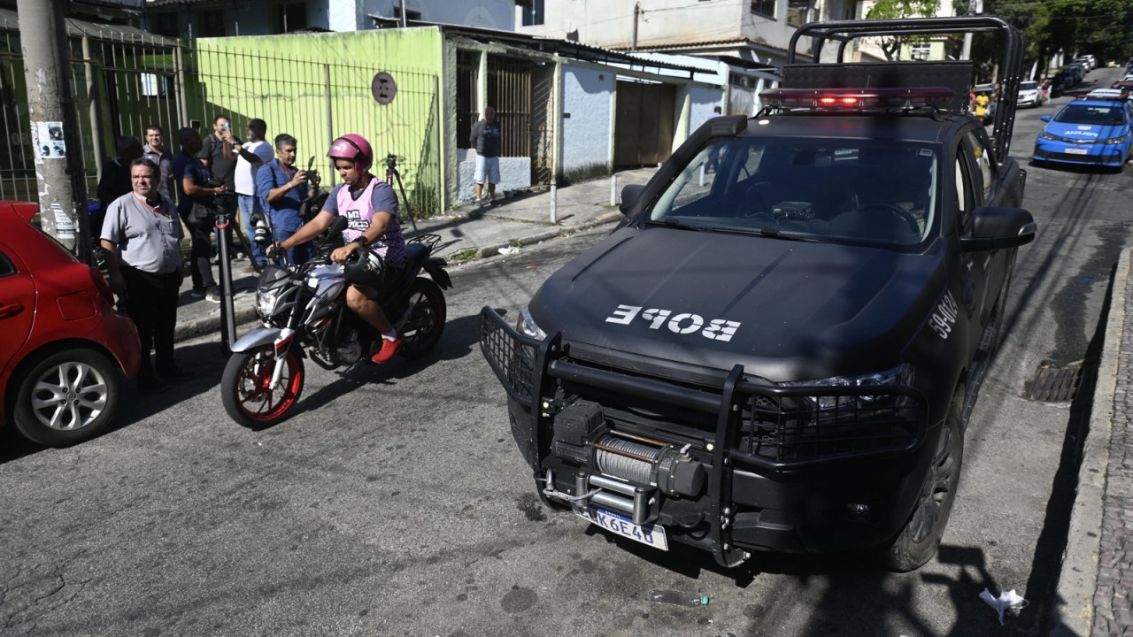 A vehicle of the Batallion of Special Police Operations (BOPE) is seen near the Getulio Vargas Hospital, where injured people were admitted after a police operation at a favela, in Rio de Janeiro, Brazil, on May 24, 2022. - A police raid in a Rio favela left 11 people dead on Tuesday, authorities said. Police said they came under gun fire as they planned to enter a slum called Vila Cruzeiro in the north of the city with the mission of locating and arresting "criminal leaders." In the ensuing gunbattle 10 alleged criminals died, as did a female resident of the favela who was hit by a stray bullet. (Photo by MAURO PIMENTEL / AFP)