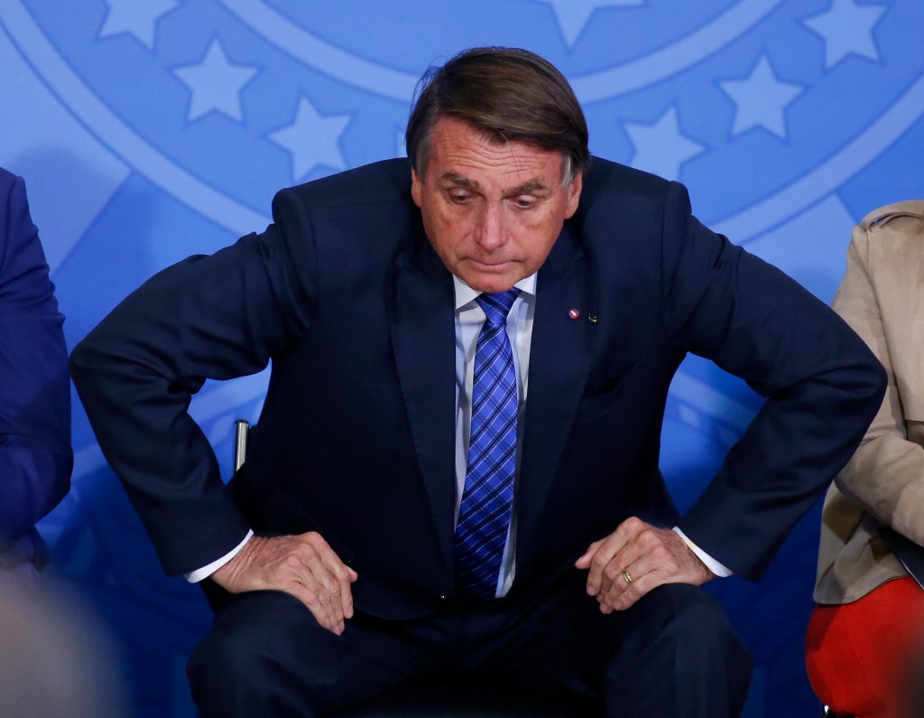 Brazil's President Jair Bolsonaro gestures during a ceremony to announce new measures for the Entrepreneurial Brazil credit program at the Planalto Palace in Brasilia, on May 25, 2022. (Photo by Sergio Lima / AFP)