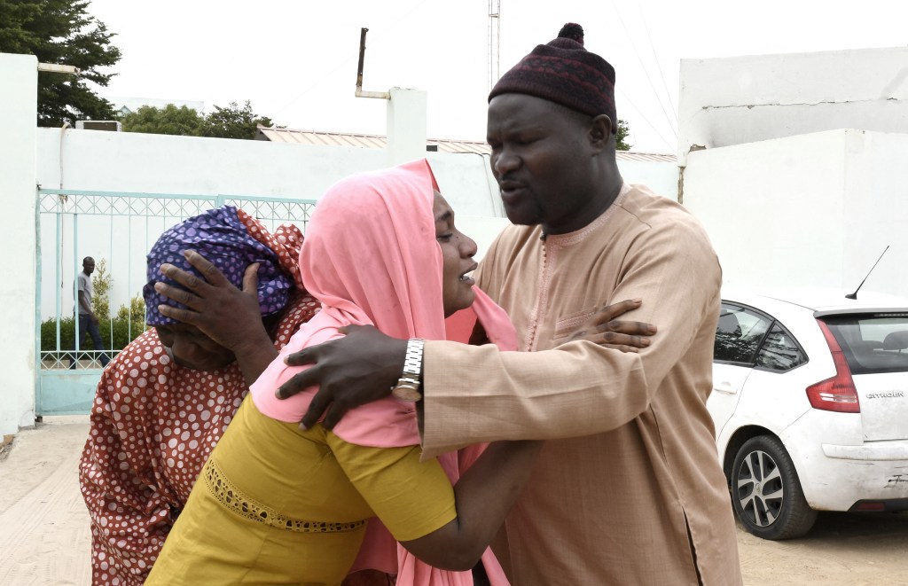 Family members console each other outside the Mame Abdoul Aziz Sy Dabakh Hospital, where eleven babies died following an electrical fault, in Tivaouane, on May 26, 2022. - Eleven newborn babies died in a hospital fire in the western Senegalese city of Tivaouane, the president of the country said late May 25, 2022. (Photo by SEYLLOU / AFP)