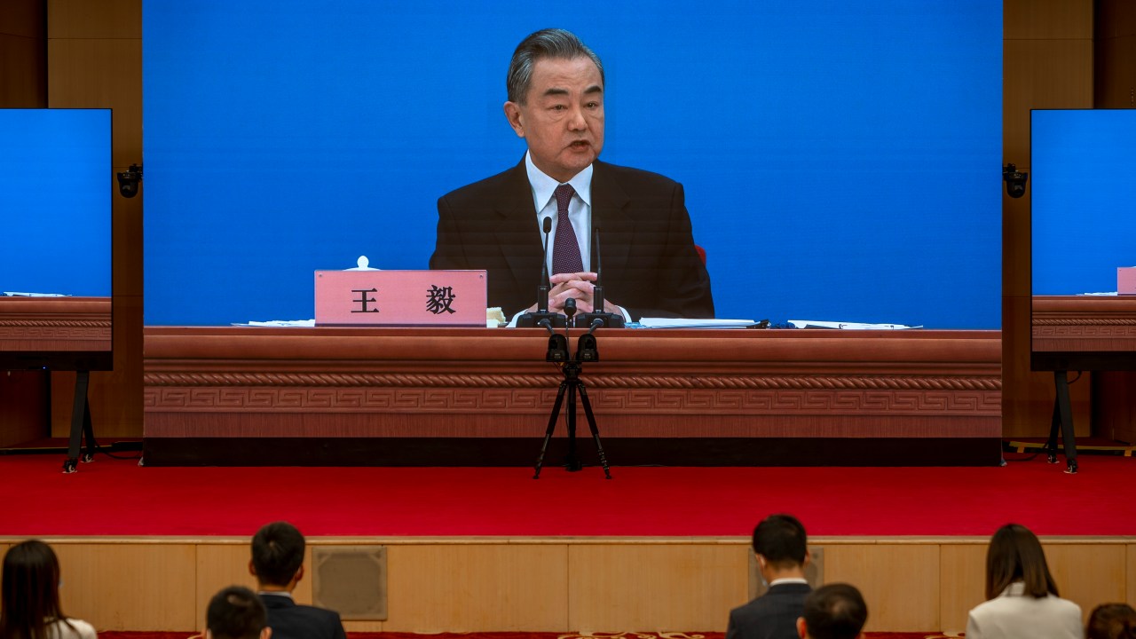 BEIJING, CHINA - MARCH 07: Chinese Foreign Minister Wang Yi is seen on large screens as he holds a press conference at the Media Center on March 07, 2022 in Beijing, China. (Photo by Andrea Verdelli/Getty Images