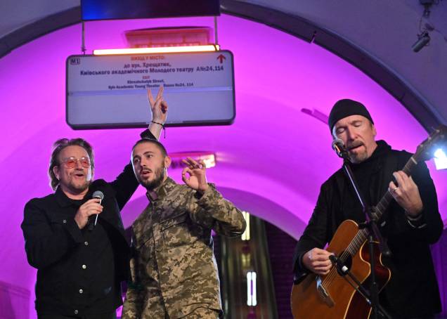 Bono (Paul David Hewson), cantor e compositor irlandês, ativista e vocalista da banda de rock U2, Antytila, líder da banda musical ucraniana, Taras Topolia e agora militar do exército ucraniano e o guitarrista David Howell Evans, 'The Edge', se apresentam na estação de metrô, que é um abrigo antiaéreo, no centro da capital ucraniana de Kiev, em 8 de maio de 2022.