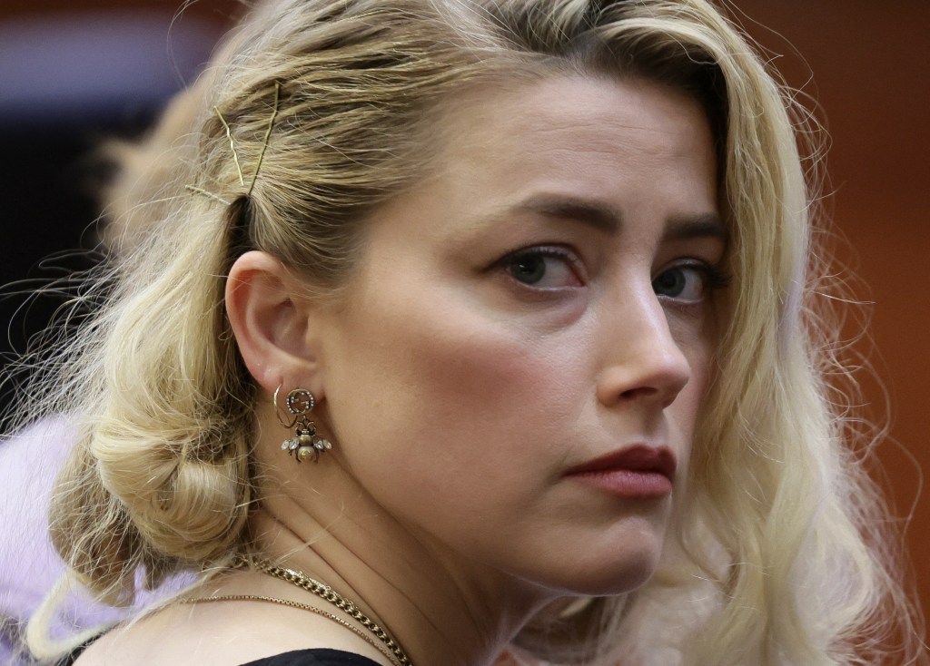 Actor Amber Heard waits before the jury said that they believe she defamed ex-husband Johnny Depp while announcing split verdicts in favor of both her ex-husband Johnny Depp and Heard on their claim and counter-claim in the Depp v. Heard civil defamation trial at the Fairfax County Circuit Courthouse in Fairfax, Virginia, on June 1, 2022. - A US jury on Wednesday found Johnny Depp and Amber Heard defamed each other, but sided far more strongly with the "Pirates of the Caribbean" star following an intense libel trial involving bitterly contested allegations of sexual violence and domestic abuse. (Photo by EVELYN HOCKSTEIN / POOL / AFP)