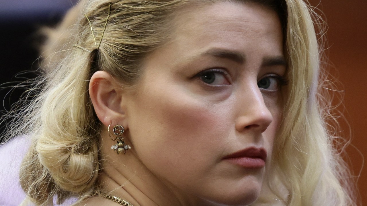 Actor Amber Heard waits before the jury said that they believe she defamed ex-husband Johnny Depp while announcing split verdicts in favor of both her ex-husband Johnny Depp and Heard on their claim and counter-claim in the Depp v. Heard civil defamation trial at the Fairfax County Circuit Courthouse in Fairfax, Virginia, on June 1, 2022. - A US jury on Wednesday found Johnny Depp and Amber Heard defamed each other, but sided far more strongly with the "Pirates of the Caribbean" star following an intense libel trial involving bitterly contested allegations of sexual violence and domestic abuse. (Photo by EVELYN HOCKSTEIN / POOL / AFP)