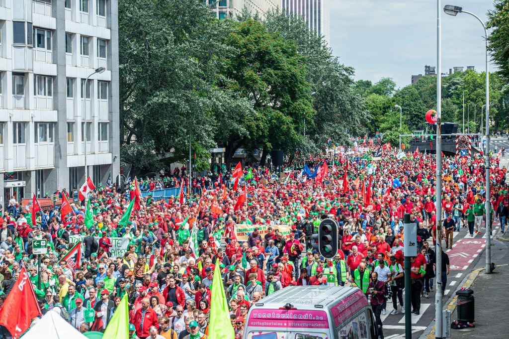 Protesters march during a national demonstration of socialist (ABVV-FGTB), christian (ACV-CSC) and liberal (ACLVB-CGSLB) trade unions, to defend purchasing power and demand an amendment to the 1996 wage standards law that regulates wage developments in Belgium, on June 20, 2022, in Brussels. (Photo by JONAS ROOSENS / BELGA / AFP) / Belgium OUT
