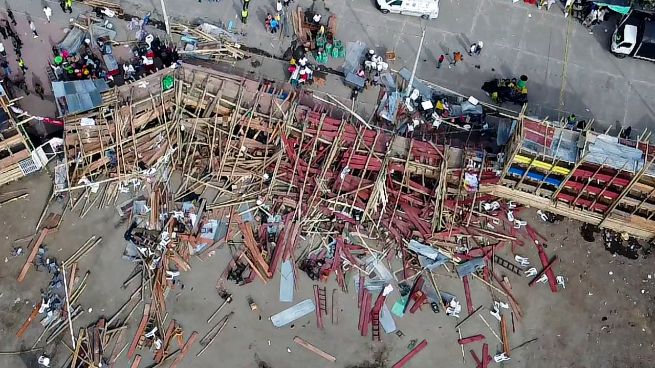 Aerial view of the collapsed grandstand in a bullring in the Colombian municipality of El Espinal, southwest of Bogotá, on June 26, 2022. - At least four people were killed and another 30 seriously injured when a full three-story section of wooden stands filled with spectators collapsed, throwing dozens of people to the ground, during a popular event at which members of the public face off with small bulls, officials said. (Photo by SAMUEL ANTONIO GALINDO CAMPOS / AFP)