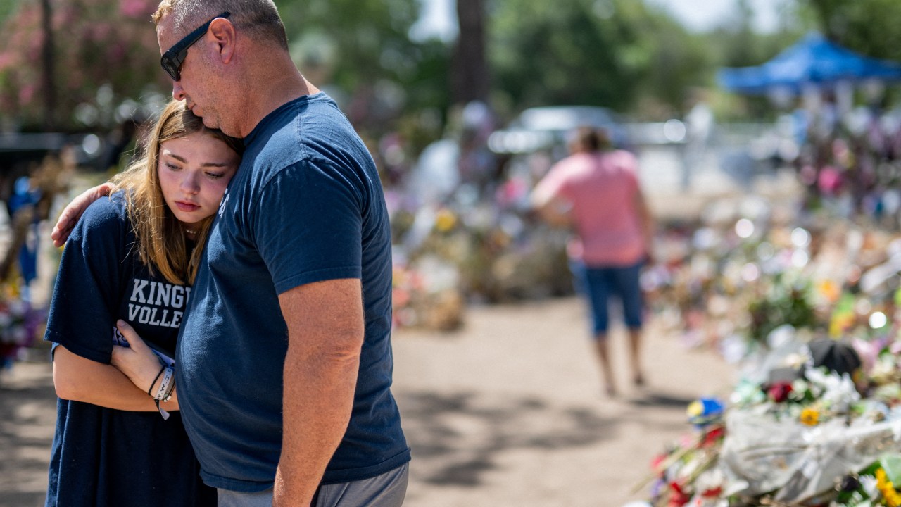 UVALDE, TEXAS - JUNE 17: Olivia Luna, 15, is comforted at a memorial in front of Robb Elementary School on June 17, 2022 in Uvalde, Texas. Committees have begun inviting testimony from law enforcement authorities, family members and witnesses regarding the mass shooting at Robb Elementary School which killed 19 children and two adults. Because of the quasi-judicial nature of the committee's investigation and pursuant to House, Section 12, witnesses will be examined in executive session. Brandon Bell/Getty Images/AFP (Photo by Brandon Bell / GETTY IMAGES NORTH AMERICA / Getty Images via AFP)