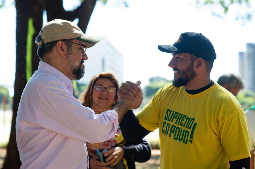 BRASILIA, BRAZIL - JUNE 14: Education Minister Abraham Weintraub shakes hands with a supporter during a meeting with supporters of President Jair Bolsonaro's government who were camped alongside the Ministry of Agriculture amidst the coronavirus (COVID-19) pandemic at Esplanada dos Ministérios on June 14, 2020 in Brasilia. This Sunday the Esplanada dos Ministérios closed to pedestrian and vehicle traffic. Brazil has over 850,000 confirmed positive cases of Coronavirus and 42,720 deaths. (Photo by Andressa Anholete/Getty Images)