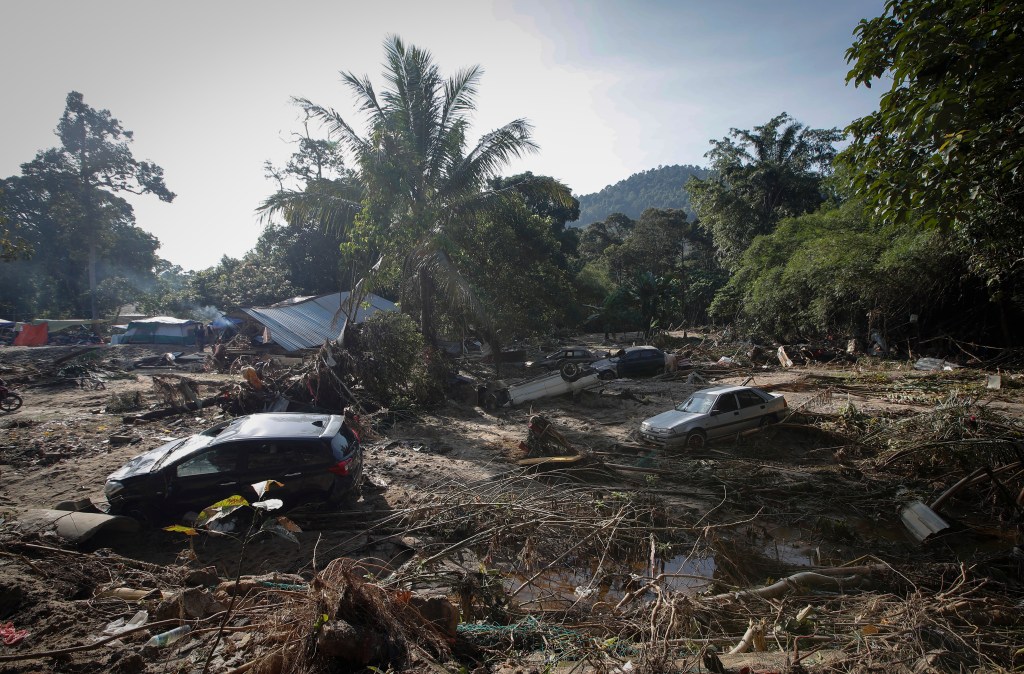 KUALA LUMPUR, MALAYSIA - 2021/12/26: Damaged cars are seen on a riverside after the massive floods at Hulu Langat, the outskirts of Kuala Lumpur. The death toll due to the flood disaster in the country has risen to forty-seven, five are still missing. (Photo by Wong Fok Loy/SOPA Images/LightRocket via Getty Images)
