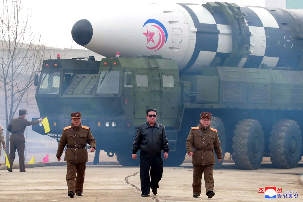This picture taken on March 24, 2022 and released from North Korea's official Korean Central News Agency (KCNA) on March 25, 2022 shows North Korean leader Kim Jong Un (C) walking near what state media report says a new type inter-continental ballistic missile (ICBM), Hwasongpho-17 of North Korea's strategic forces before its test launch in an undisclosed location in North Korea. (Photo by various sources / AFP) / South Korea OUT / ---EDITORS NOTE--- RESTRICTED TO EDITORIAL USE - MANDATORY CREDIT "AFP PHOTO/KCNA VIA KNS" - NO MARKETING NO ADVERTISING CAMPAIGNS - DISTRIBUTED AS A SERVICE TO CLIENTS / THIS PICTURE WAS MADE AVAILABLE BY A THIRD PARTY. AFP CAN NOT INDEPENDENTLY VERIFY THE AUTHENTICITY, LOCATION, DATE AND CONTENT OF THIS IMAGE --- /