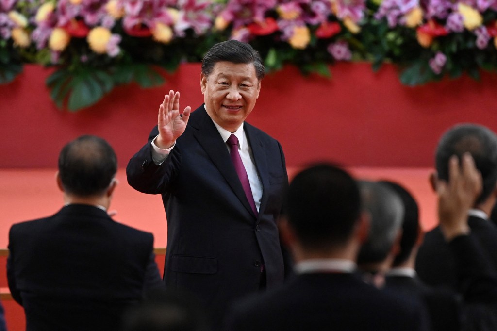 China's President Xi Jinping waves following his speech after a ceremony to inaugurate the city's new leader and government in Hong Kong on July 1, 2022, on the 25th anniversary of the city's handover from Britain to China. (Photo by Selim CHTAYTI / POOL / AFP)