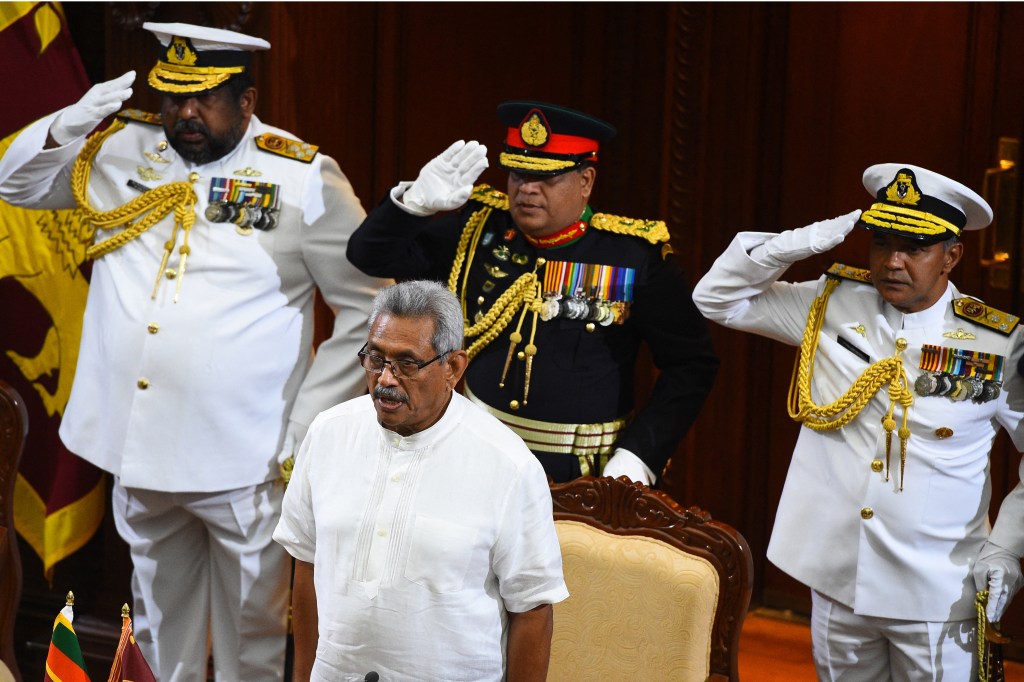 (FILES) In this file photo taken on November 22, 2019, Sri Lanka's new President Gotabaya Rajapaksa (C) stands for the national anthem before the start of a ministerial swearing-in ceremony in Colombo. - Millions of rupees in cash left behind by President Gotabaya Rajapaksa when he fled his official residence in the capital will be handed over to court on July 11, 2022, police said. (Photo by ISHARA S. KODIKARA / AFP)