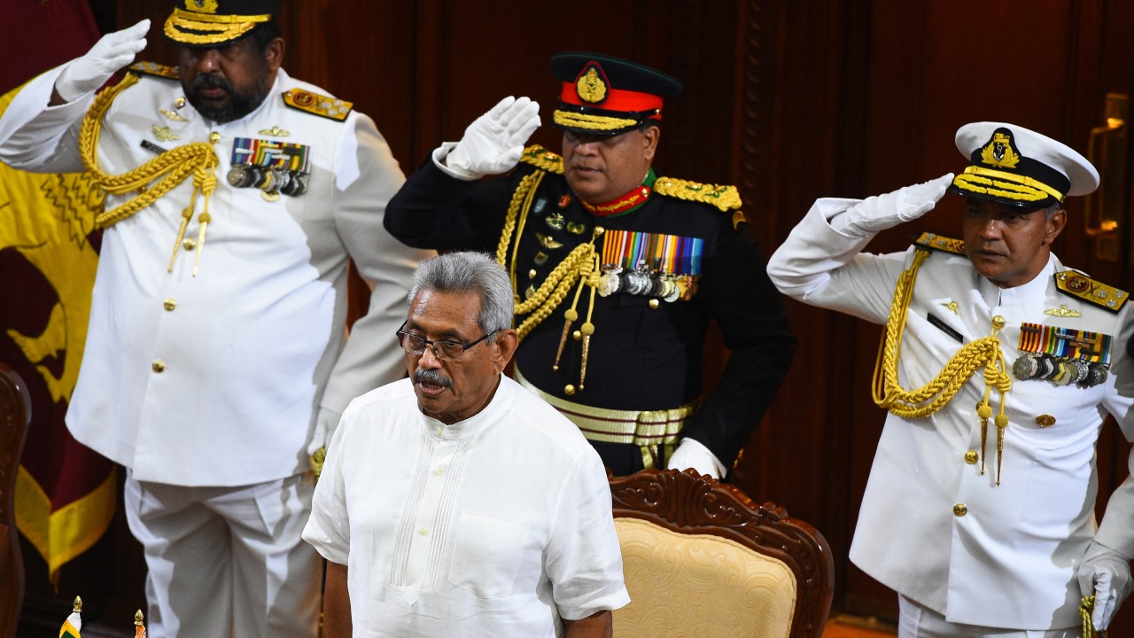 (FILES) In this file photo taken on November 22, 2019, Sri Lanka's new President Gotabaya Rajapaksa (C) stands for the national anthem before the start of a ministerial swearing-in ceremony in Colombo. - Millions of rupees in cash left behind by President Gotabaya Rajapaksa when he fled his official residence in the capital will be handed over to court on July 11, 2022, police said. (Photo by ISHARA S. KODIKARA / AFP)