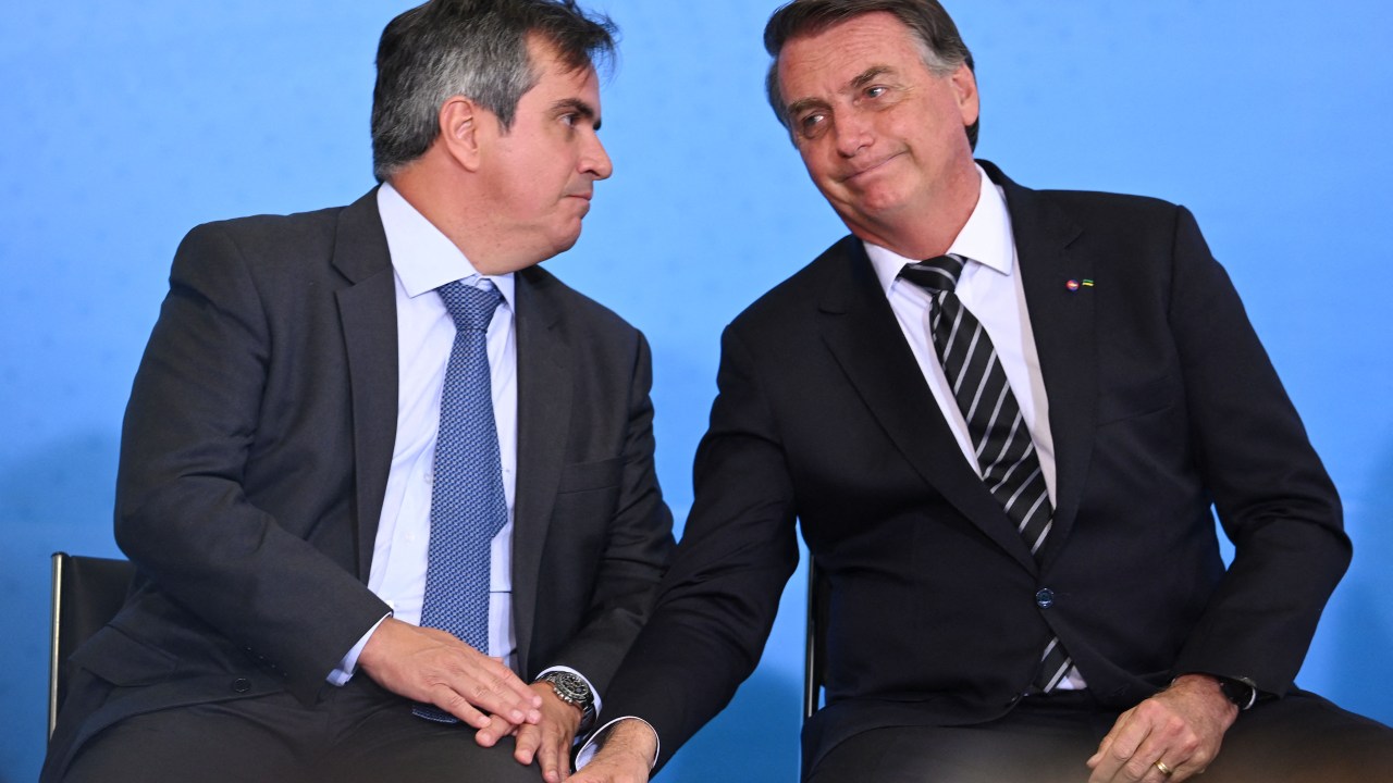 Brazilian President Jair Bolsonaro (R) and his Chief of Staff Ciro Nogueira talk during the celebration of National Volunteer Day at Planalto Palace in Brasilia, August 26, 2021 (Photo by EVARISTO SA / AFP)