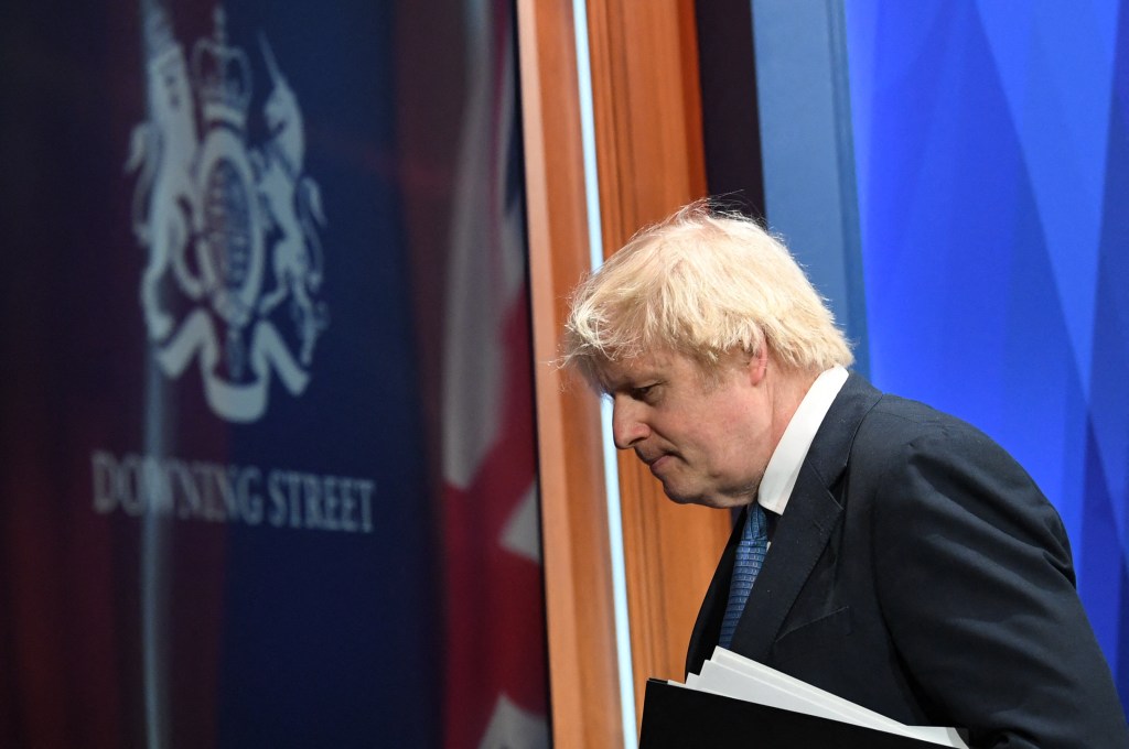 (FILES) In this file photo taken on April 05, 2021 Britain's Prime Minister Boris Johnson leaves after giving an update on the coronavirus Covid-19 pandemic during a virtual press conference inside the new Downing Street Briefing Room in central London. - Britain's finance minister Rishi Sunak and Health Minister Sajid Javid both on July 5, 2022, announced thier resignations, as Prime Minister Boris Johnson came under fire for his handling of a sleaze scandal involving a senior colleague. (Photo by Stefan Rousseau / POOL / AFP)