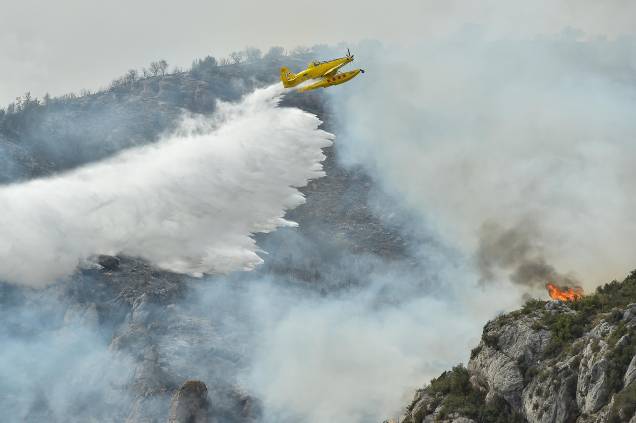 Um avião de combate a incêndios Air Tractor AT-802 solta água durante operações de contenção de incêndio perto de Artesa de Segre, na Catalunha, Espanha, em 16/06/2022.